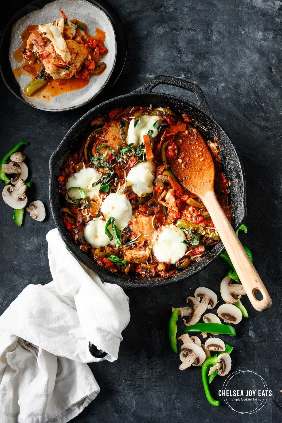 Overhead view of gluten free skillet pizza chicken casserole with a serving spoon