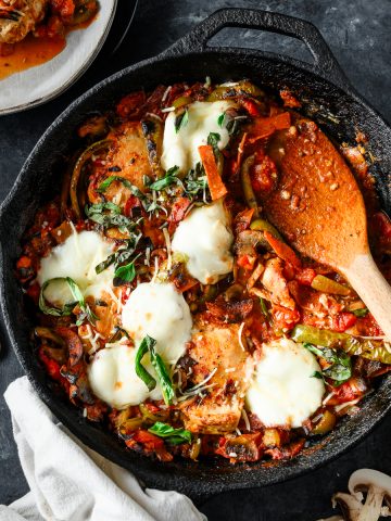 Overhead view of a chicken and pepperoni casserole served in a cast iron skillet