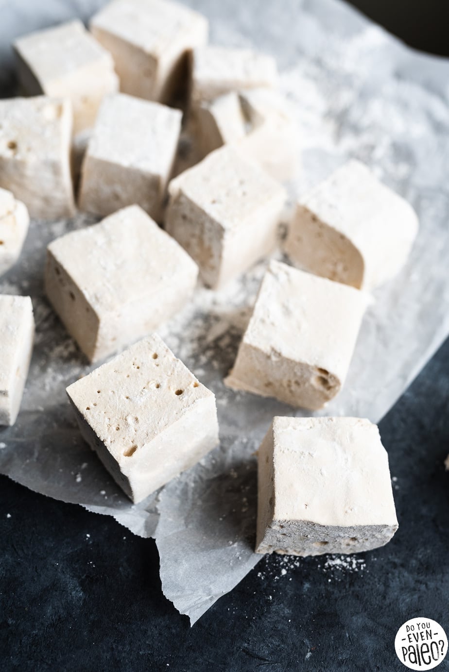Multiple homemade marshmallows on a dark background