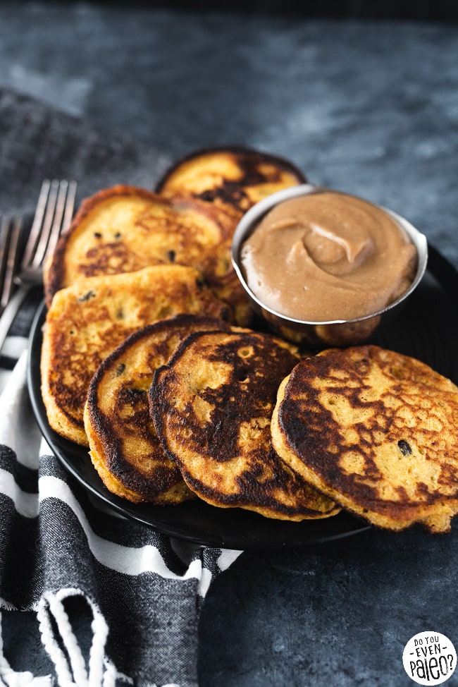 Plate of paleo plantain & raisin fritters with a bowl of date caramel dipping sauce