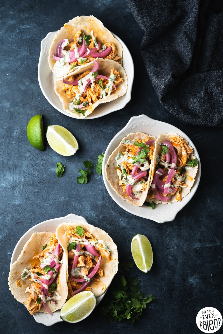 Small plates with buffalo chicken tacos topped with pickled red onions and homemade ranch