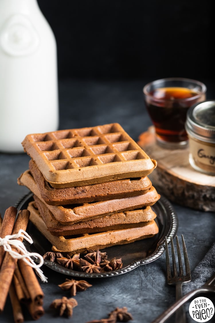 Stack of gluten free waffles on a vintage plate with cinnamon sticks and star anise