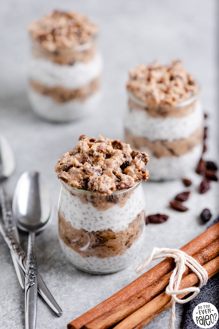 Jars of chia pudding with spoons and cinnamon sticks