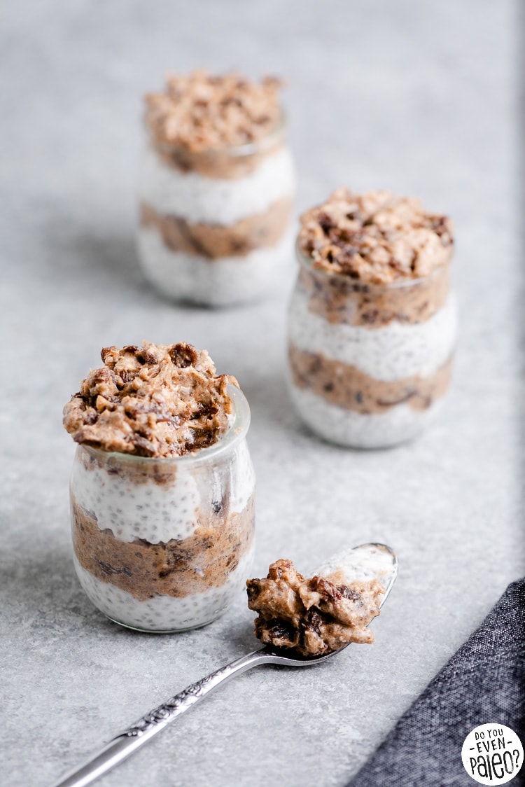 Jars of cinnamon raisin chia pudding and a spoonful of chia pudding resting on the table