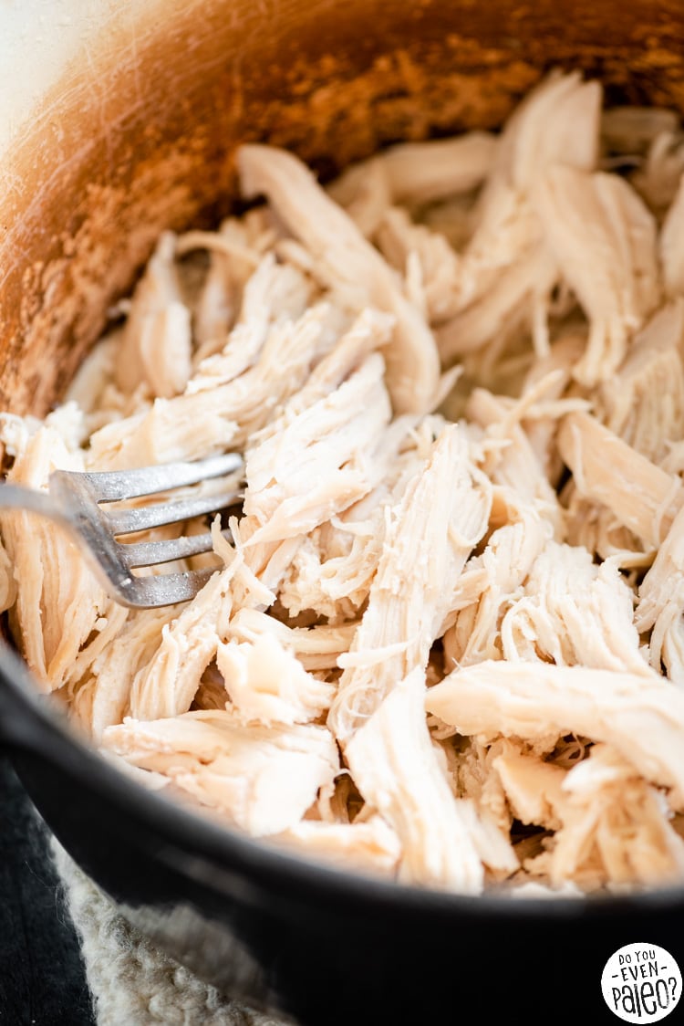 Closeup of shredded chicken in a dutch oven