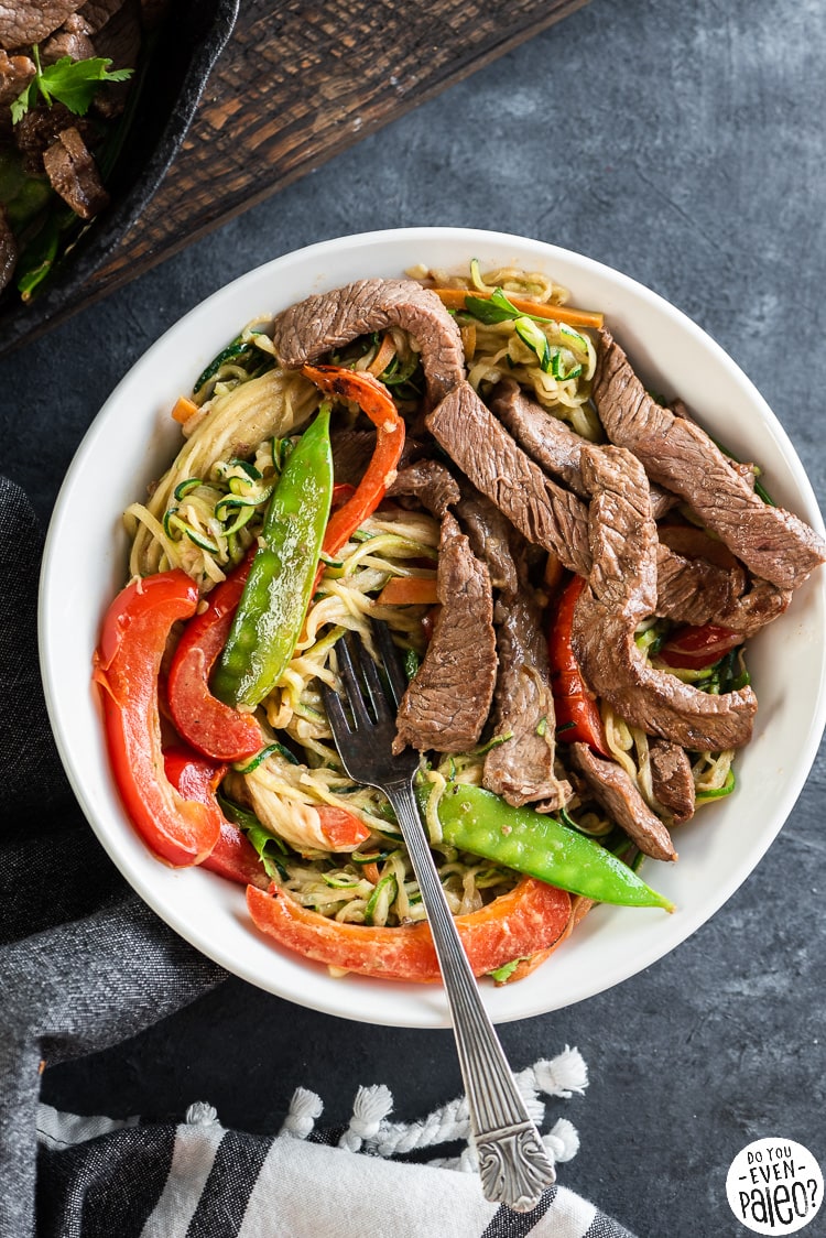 Bowl full of Thai beef stir fry with zucchini noodles and vegetables