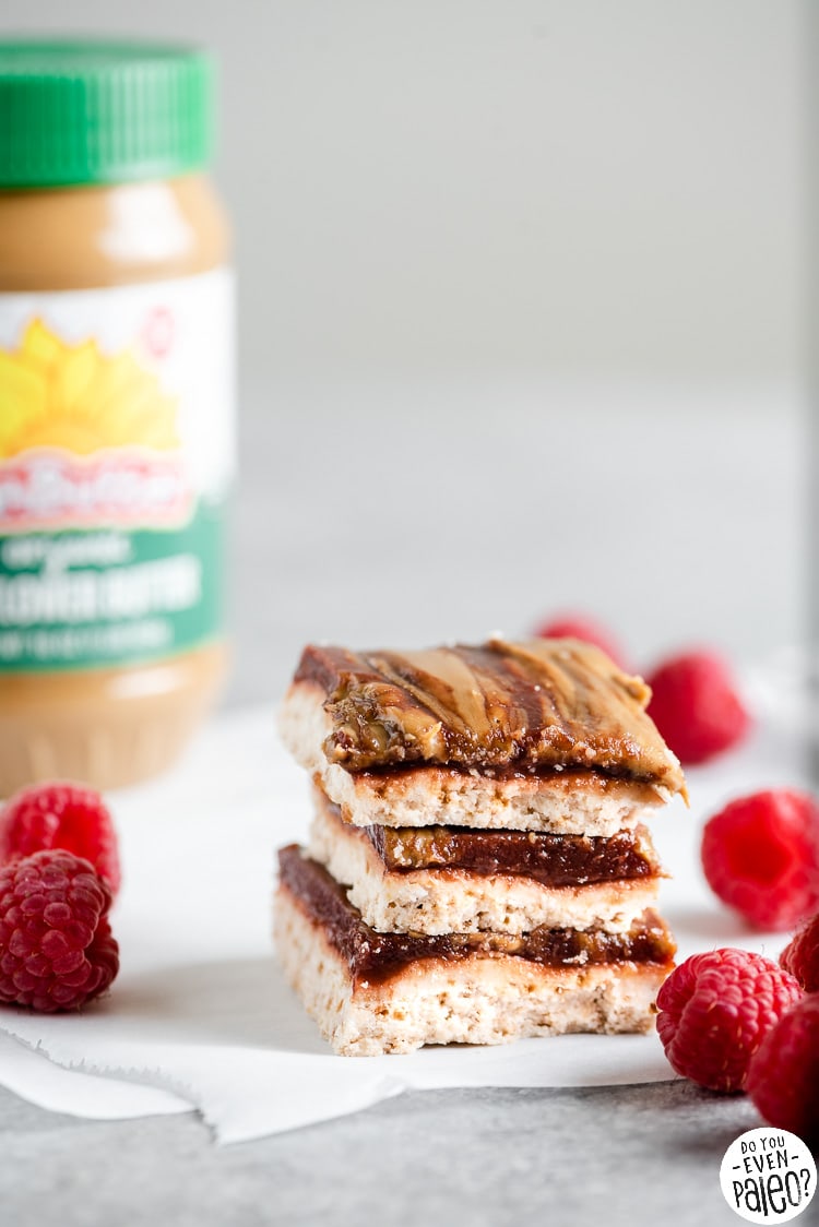 Stack of SunButter and Jelly Bars next to a jar of SunButter