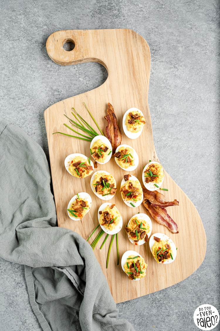Chive bacon deviled eggs on a wooden platter