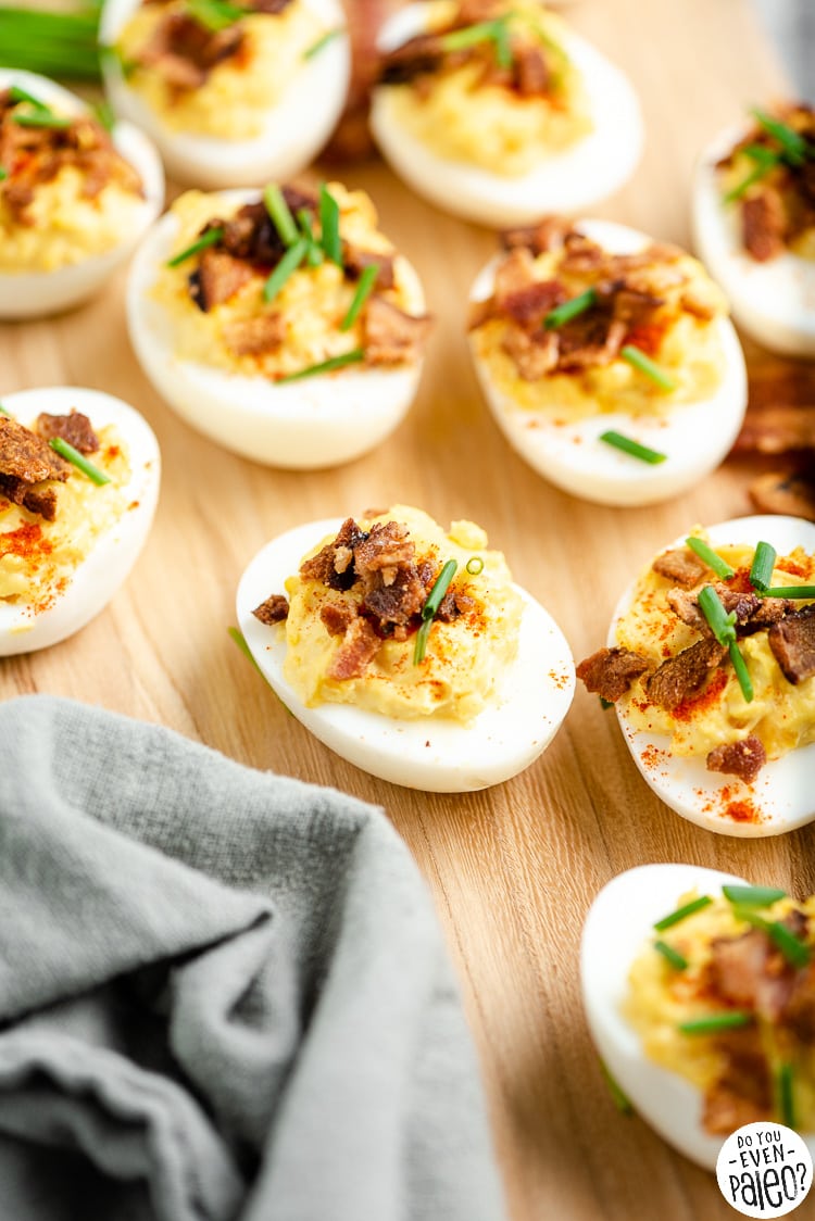 Closeup of deviled eggs on a wooden platter
