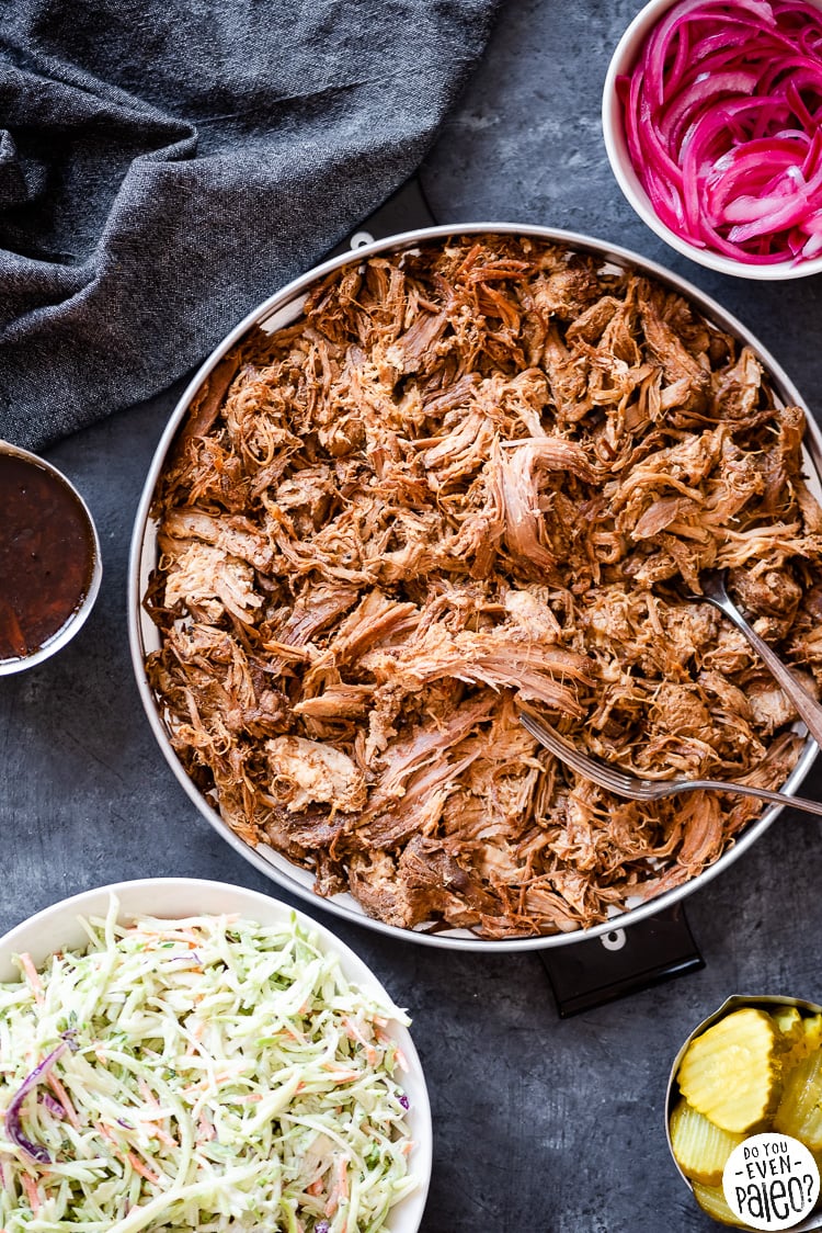 Serving tray of chipotle pulled pork with pickled onions and coleslaw