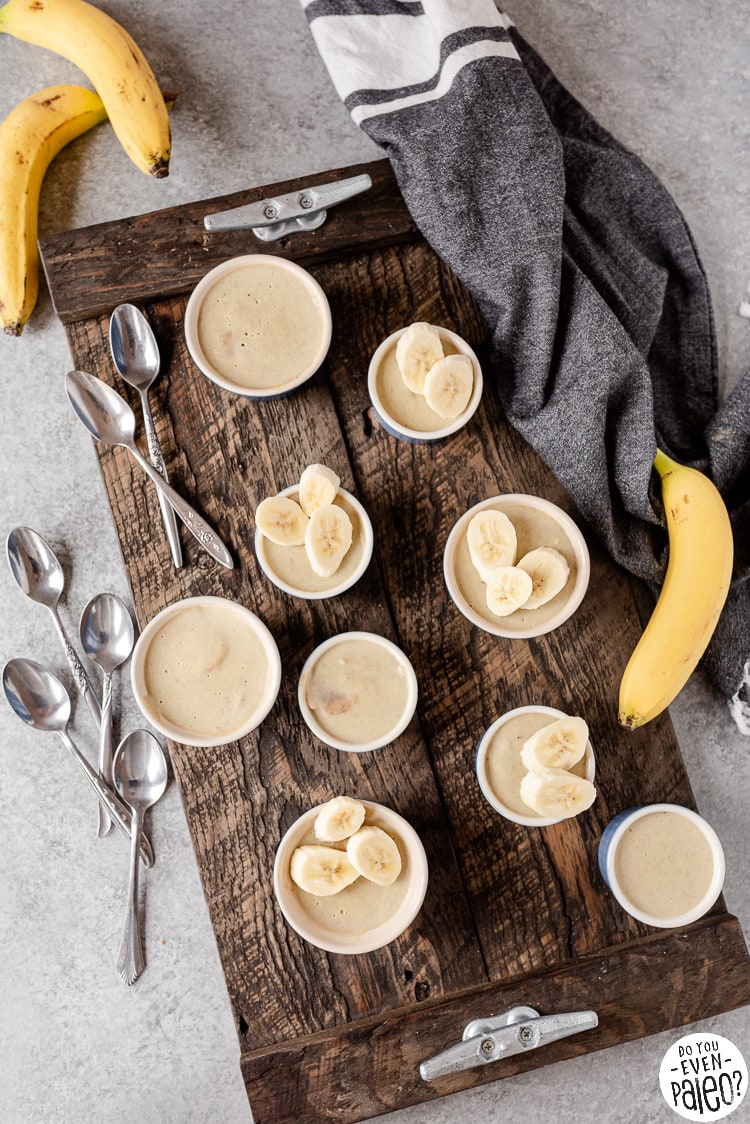 Bird's eye view of a tray of banana custards in ramekins