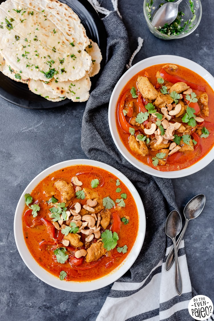 Bowls of paleo chicken curry with flatbread