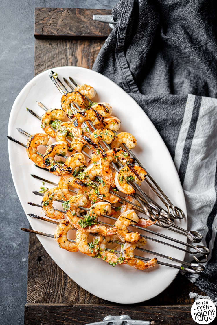 Platter with skewers of herbed grilled shrimp