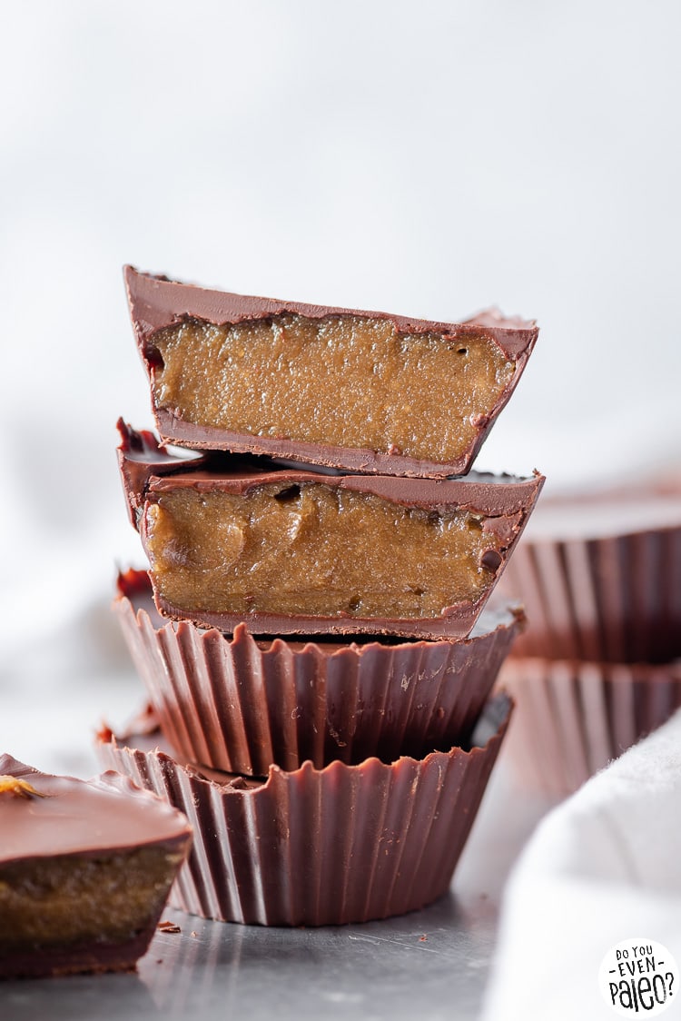 Closeup view of homemade sunflower seed butter cups, one sliced in half