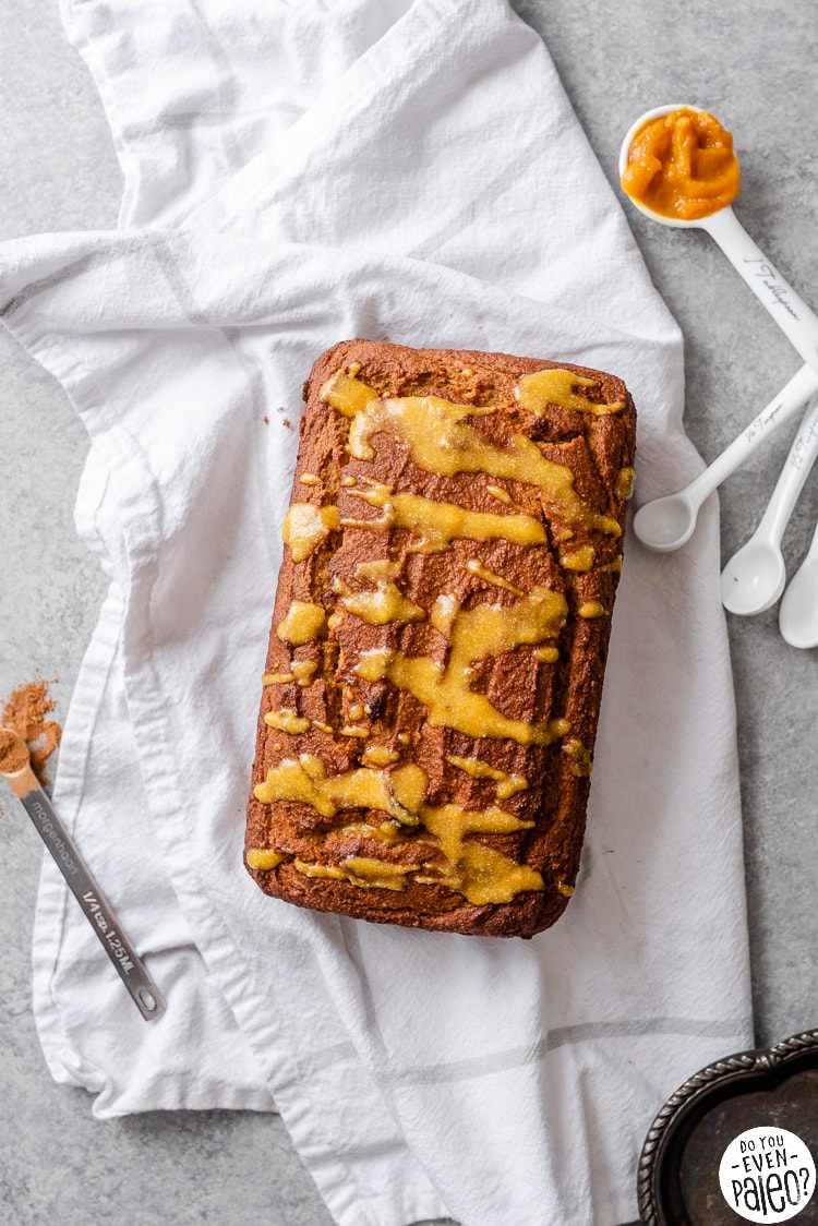 Loaf of gluten free honey pumpkin bread on a white linen