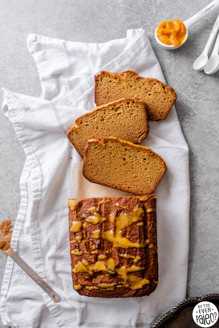 Half-sliced loaf of gluten free honey pumpkin bread