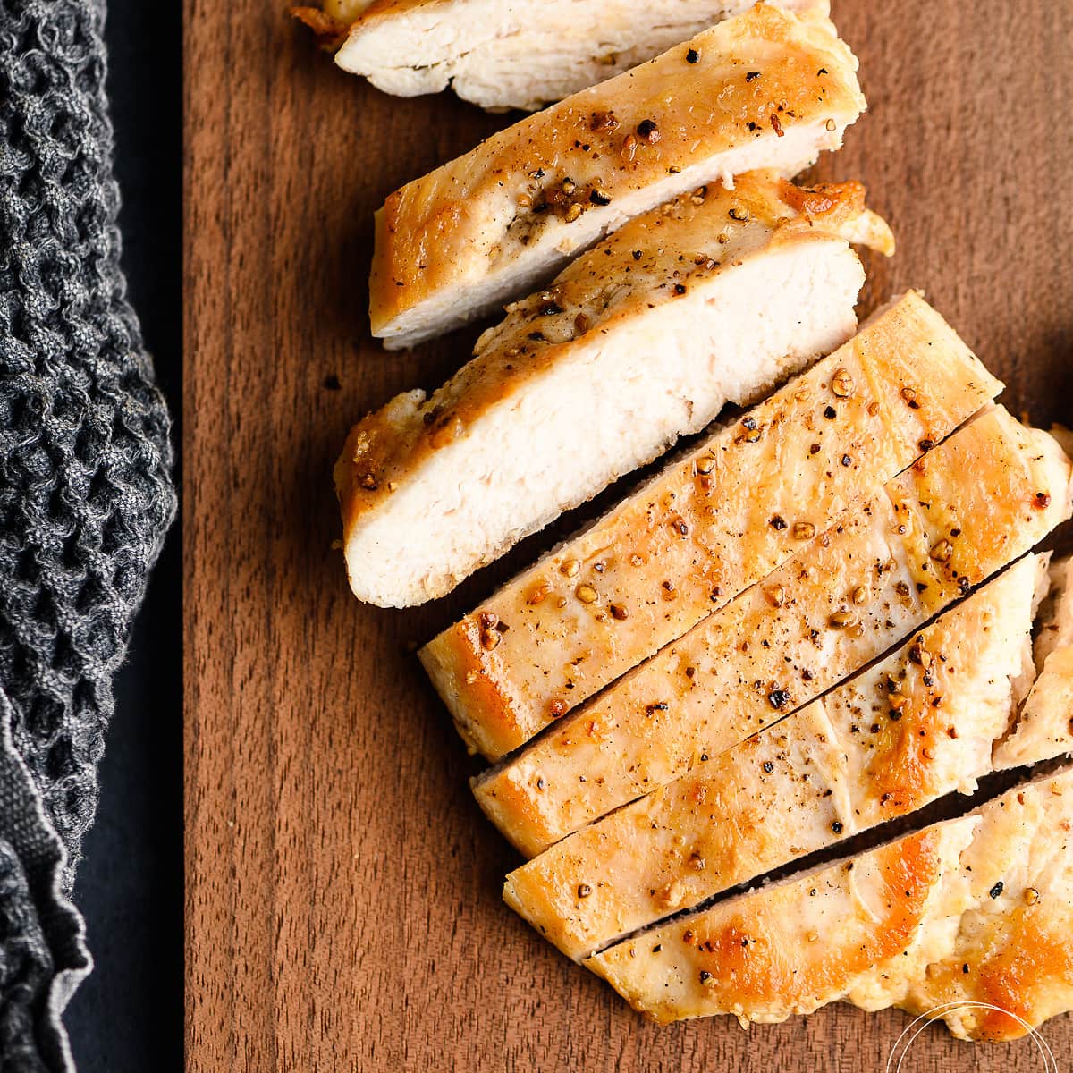 Chicken breast slices on a cutting board