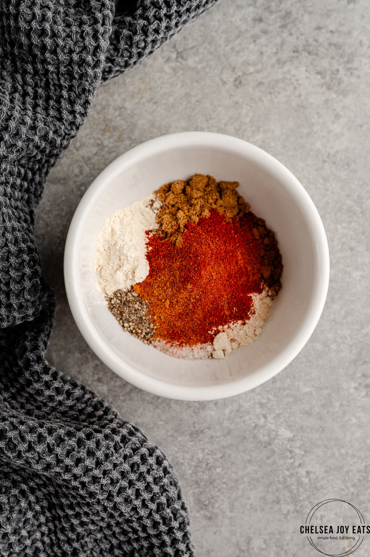 Unblended spices for homemade seasoning piled in a shallow dish