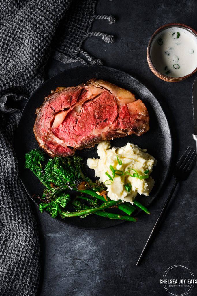 Dinner plate with a serving of smoked prime rib, broccolini, and mashed potatoes