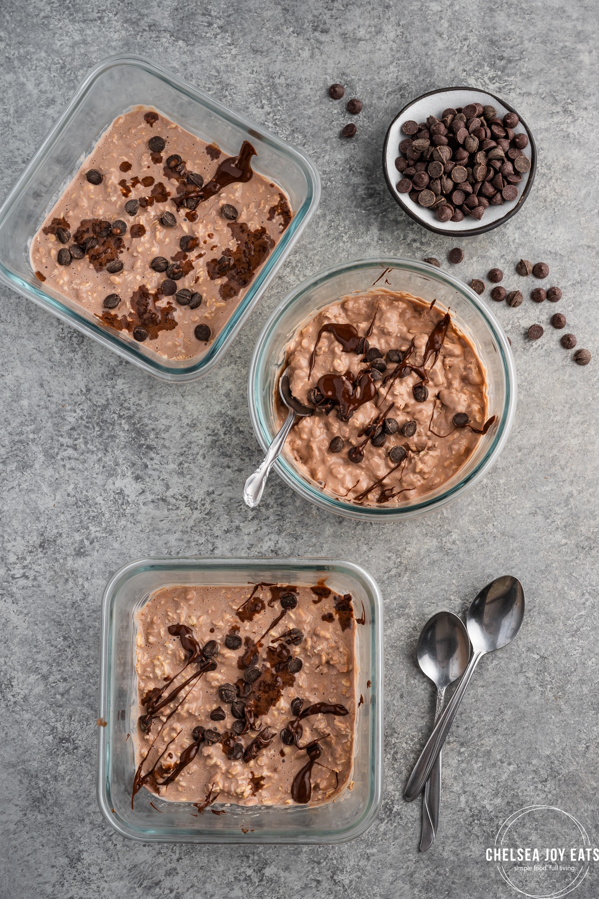 Containers of chocolate protein overnight oatmeal drizzled in chocolate
