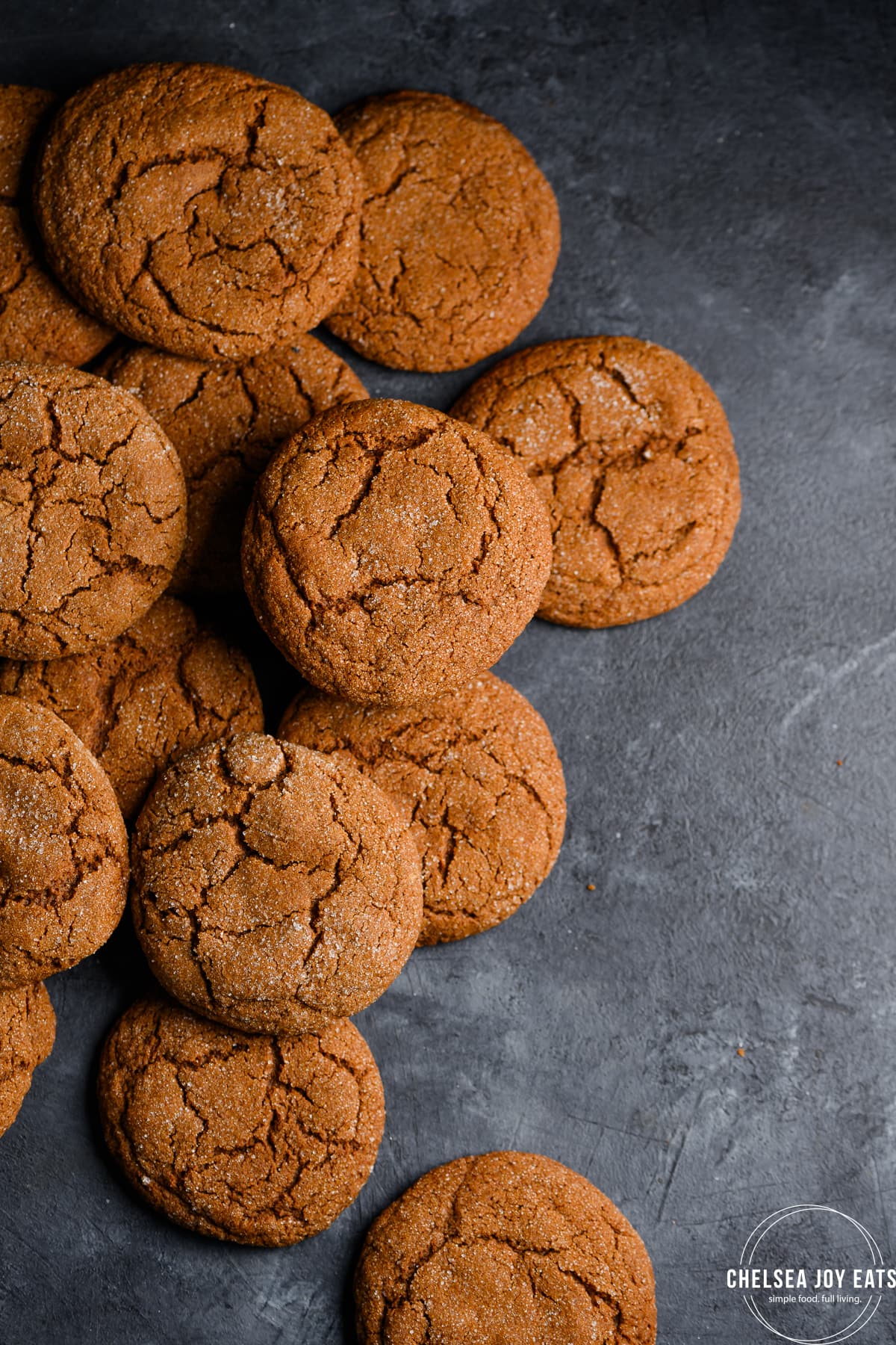 Gluten free molasses cookies arranged on a dark background