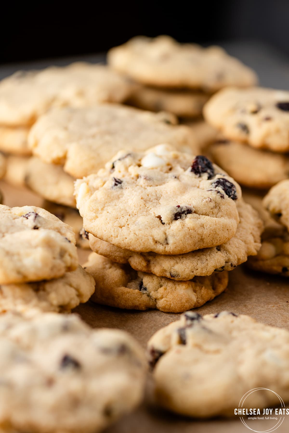 Gluten free white chocolate cranberry cookies stacked on a tray
