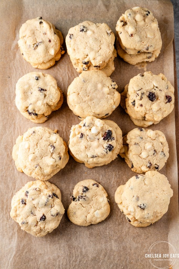 White chocolate cranberry cookies cooling on a rack lined with parchment paper