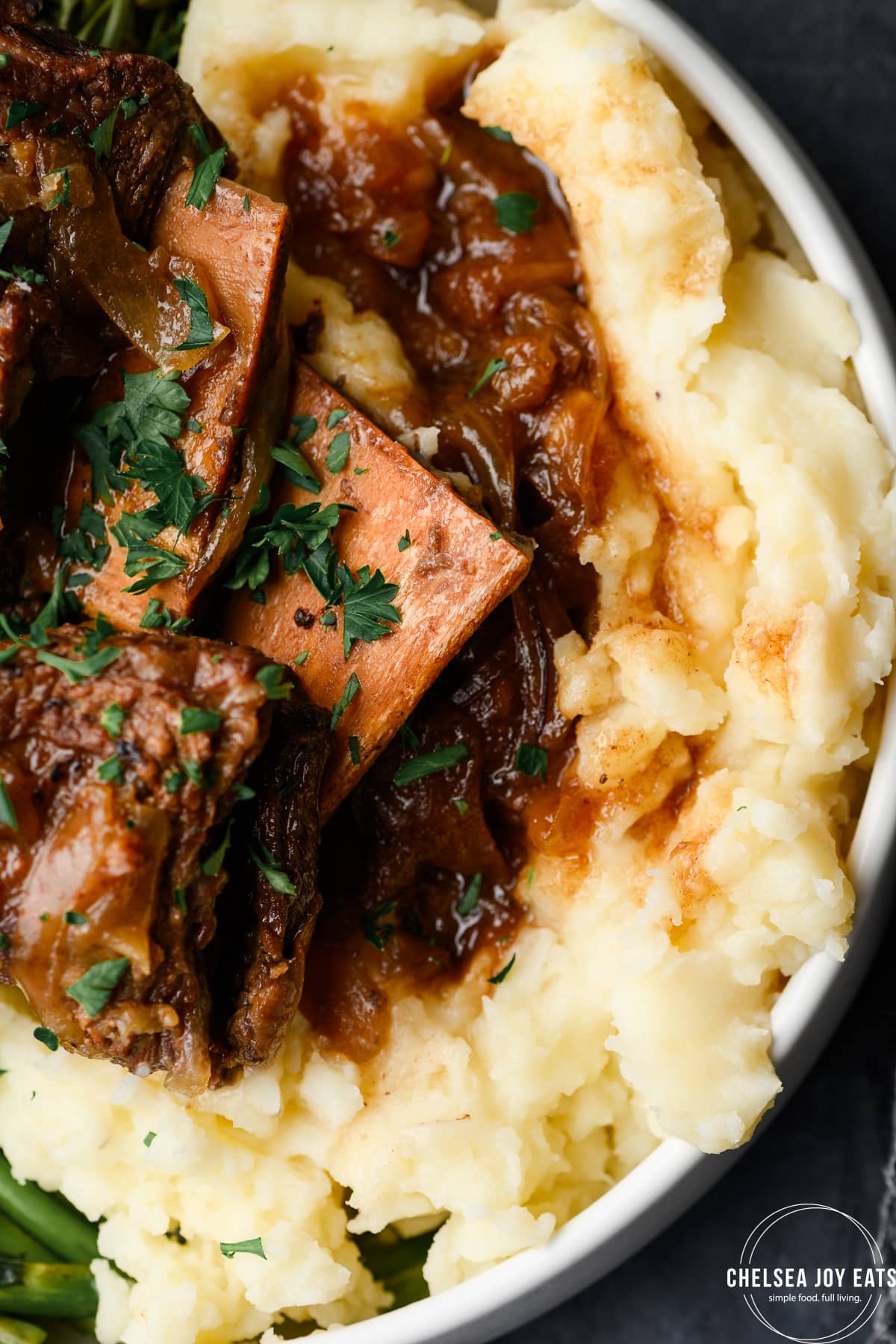Closeup of brasied short ribs over mashed potatoes