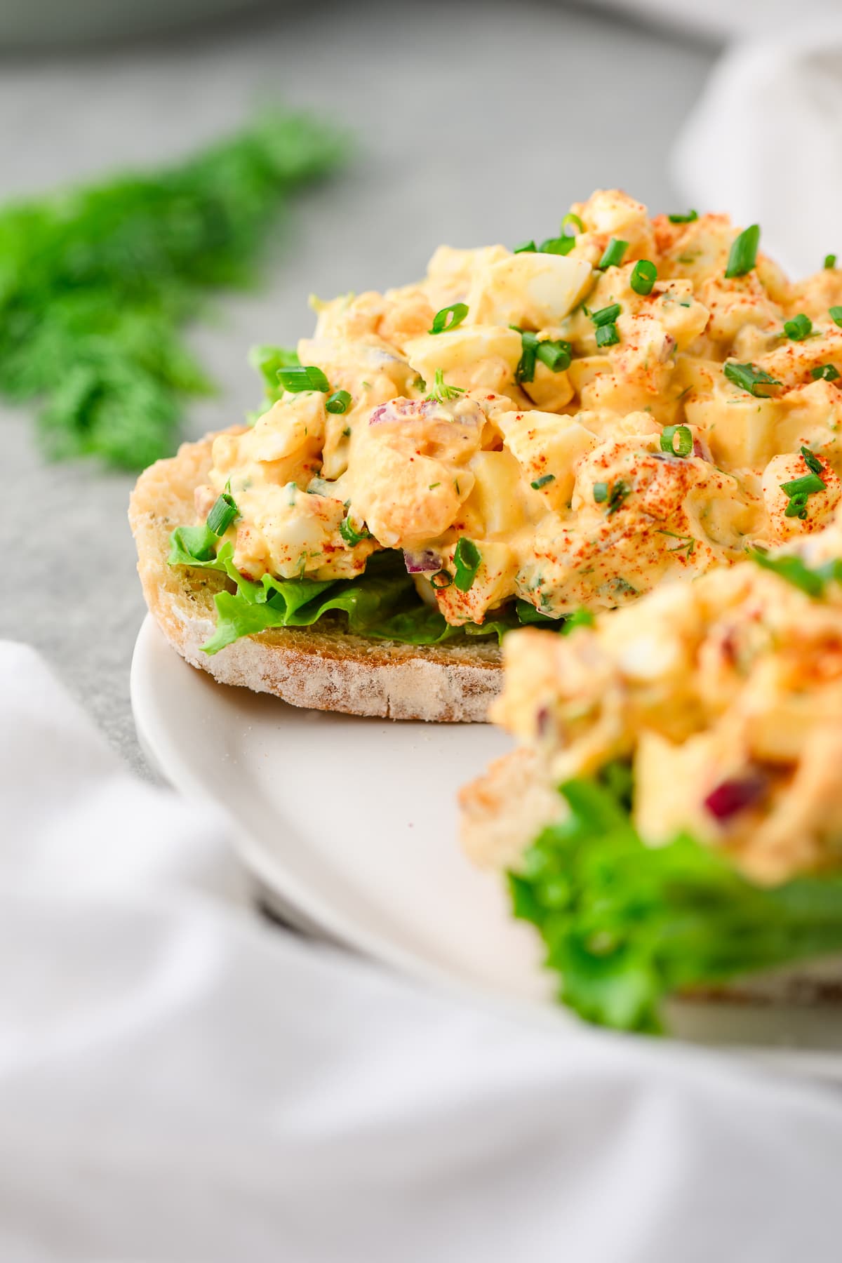 Closeup of egg salad made with cottage cheese served over lettuce and sourdough toast