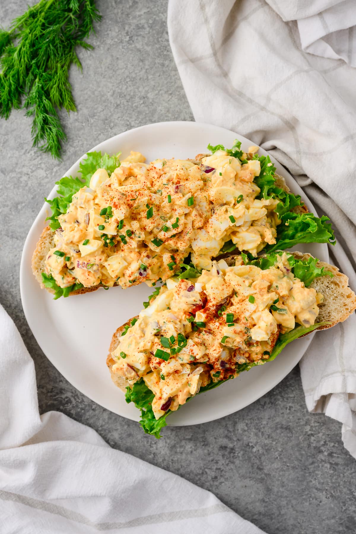 Overhead view of cottage cheese egg salad served over slices of sourdough bread