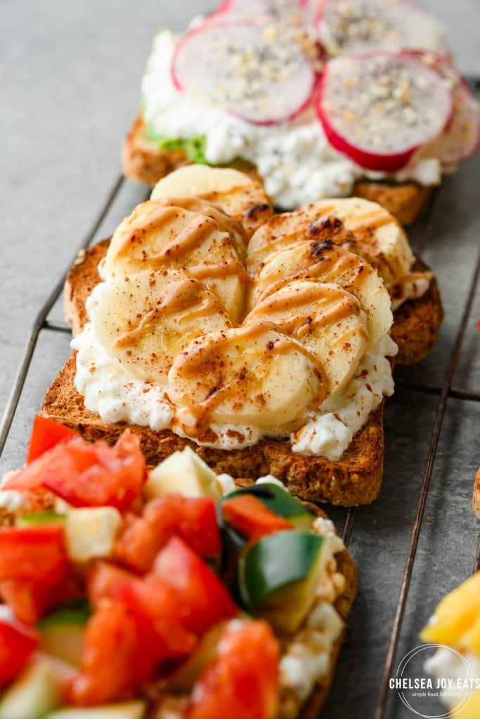Closeup of cottage cheese toast topped with sliced banana, peanut butter, and cinnamon