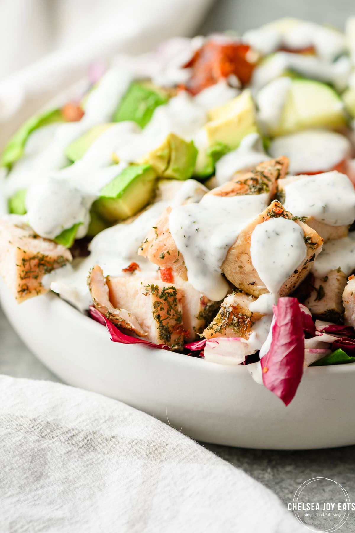 Closeup view of chicken bacon ranch salad smothered with dressing