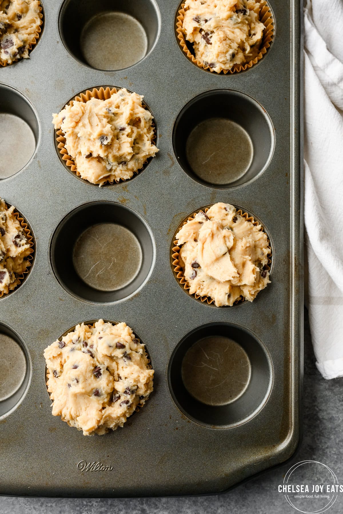 Muffin batter ready to bake in a muffin tin