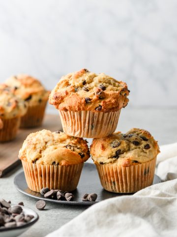 Gluten free chocolate chip muffins stacked on top of one another