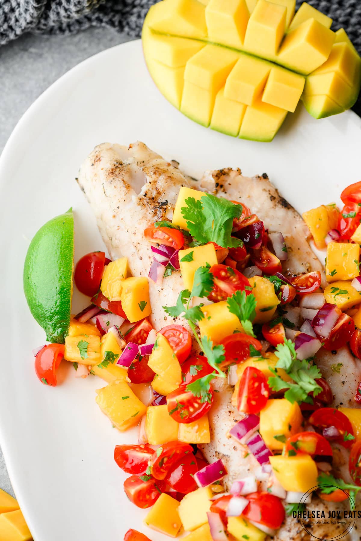 Close-up view of walleye fillet served on a tray with mango salsa