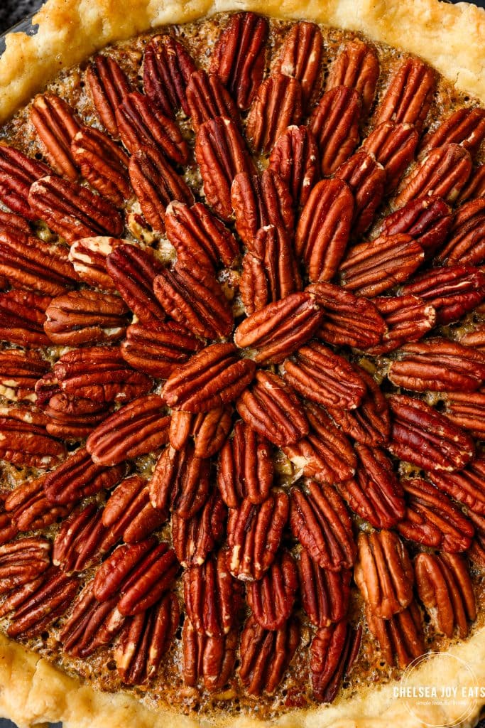 Close-up view of pecans layered on top of a pie