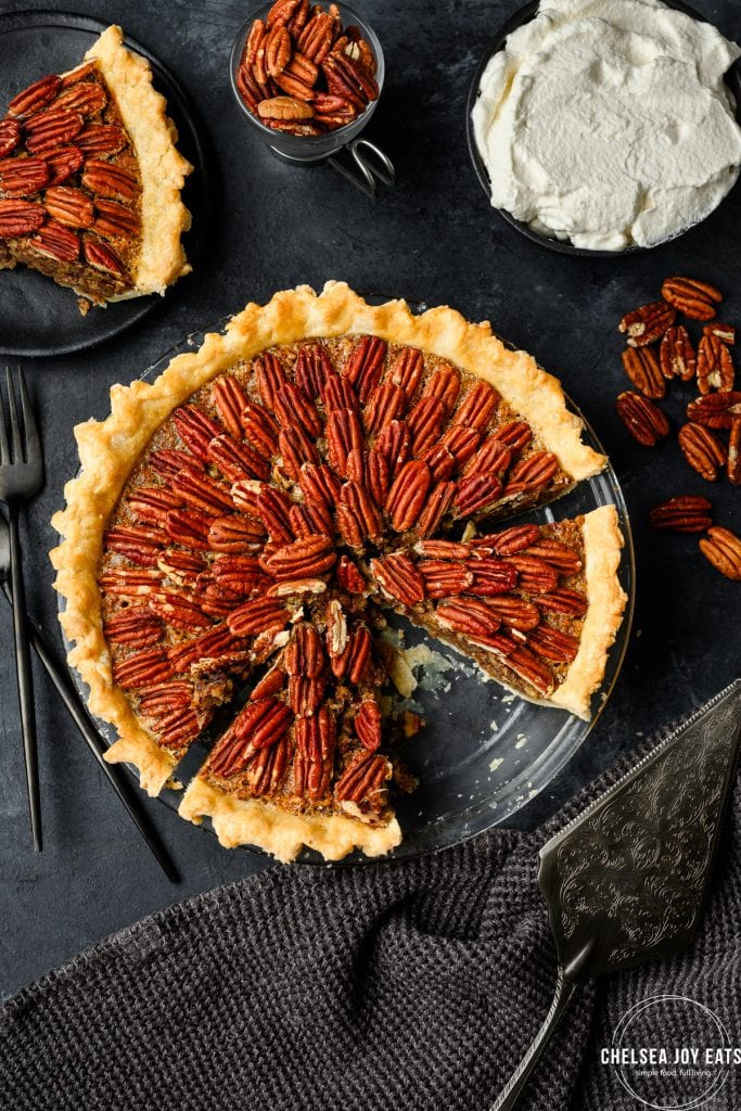 Overhead view of a pecan pie with multiple slices cut and one missing