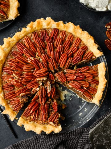 Overhead view of a gluten free pecan pie with a few cut pieces and one piece missing