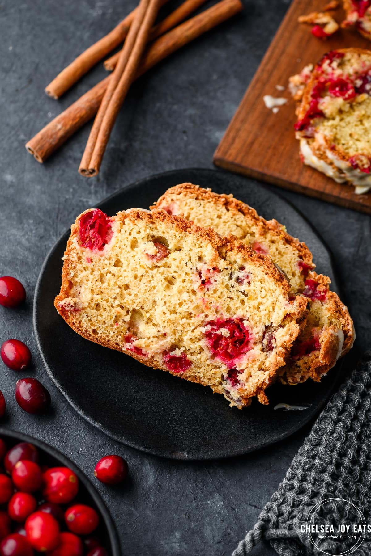 Slices of gluten free cranberry bread on a small black plate