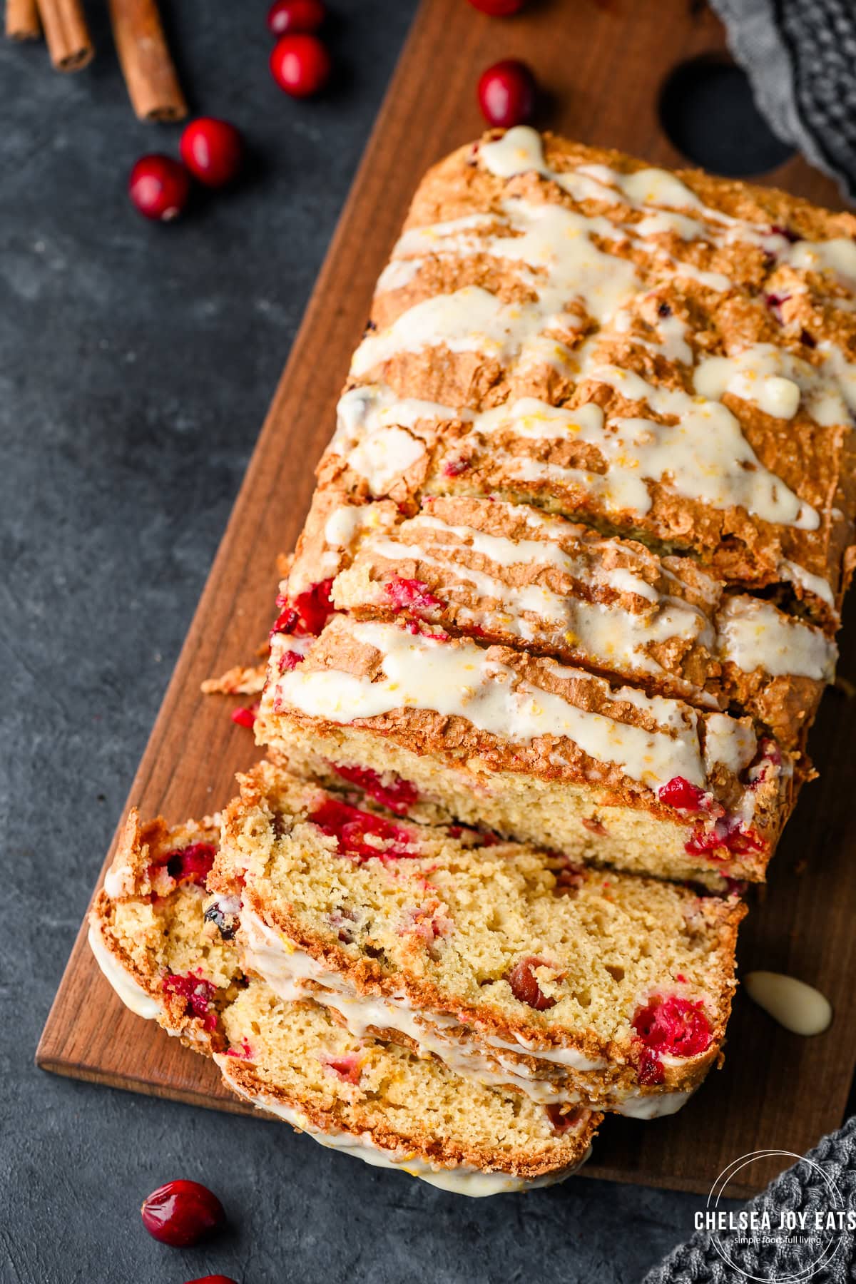 Overhead view of a partially sliced loaf of gluten free cranberry quick bread