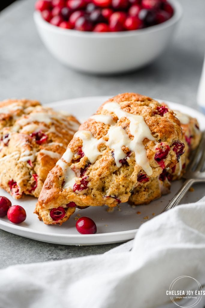 Closeup view of a gluten free cranberry orange scone on a plate