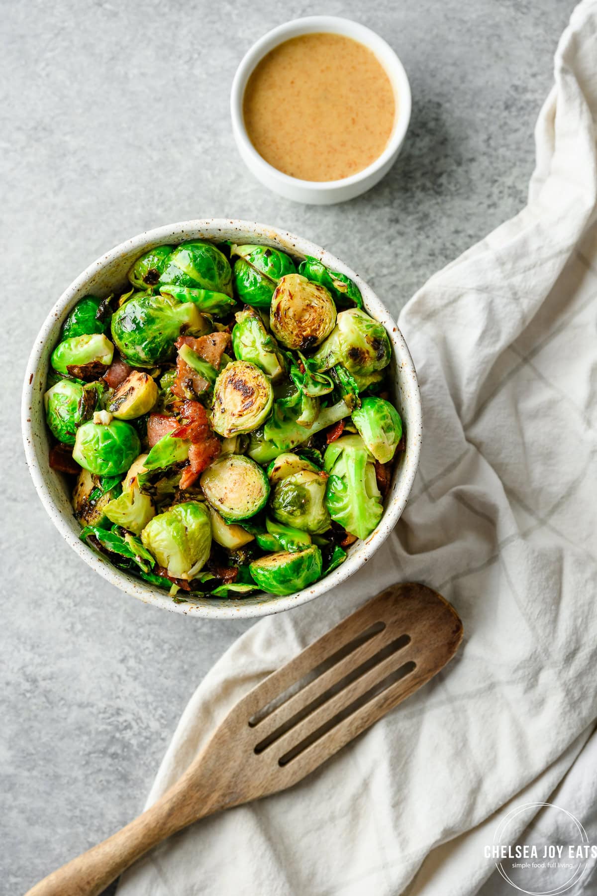 Overhead view of a bowl of Honey Mustard Brussels Sprouts with bacon
