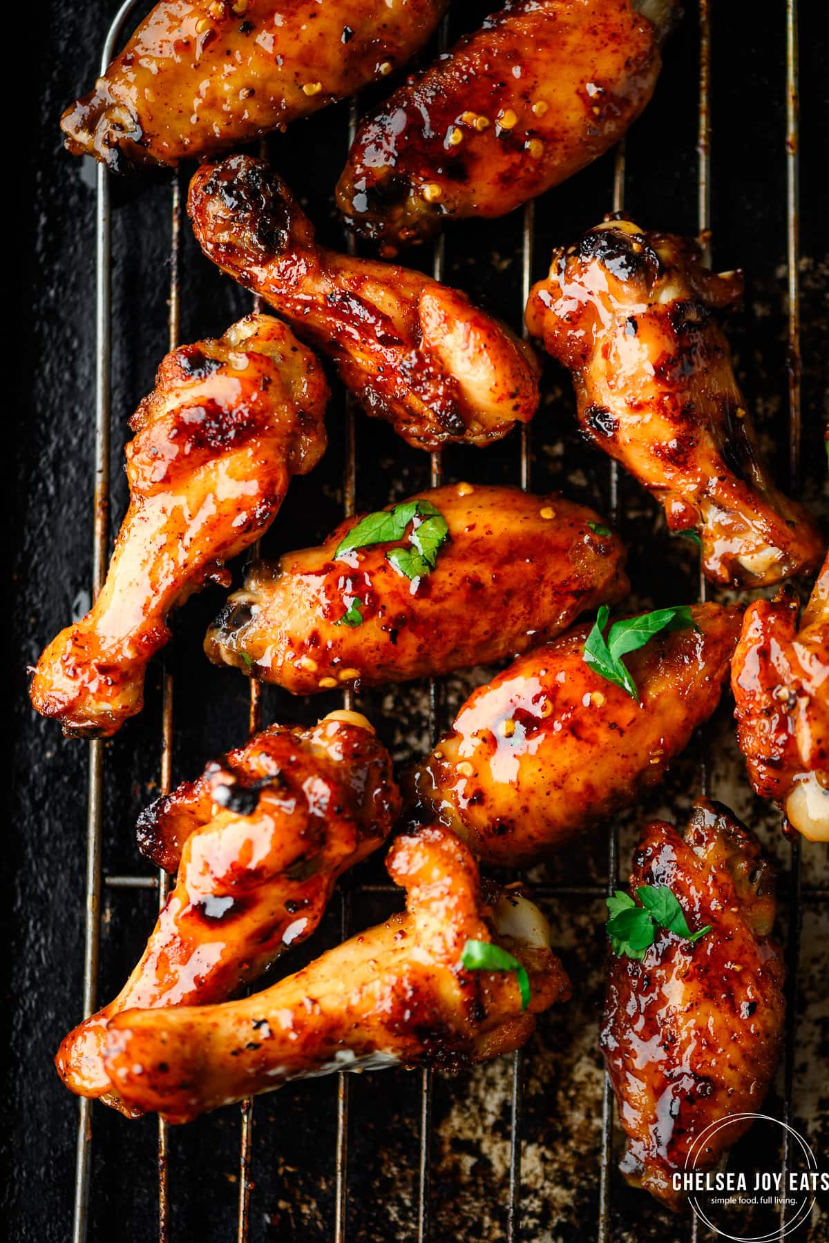 Chicken wings glazed with hot honey sauce on a wire rack