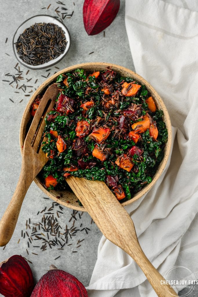 Overhead view of a serving bowl filled with roasted beet and butternut squash salad with wild rice