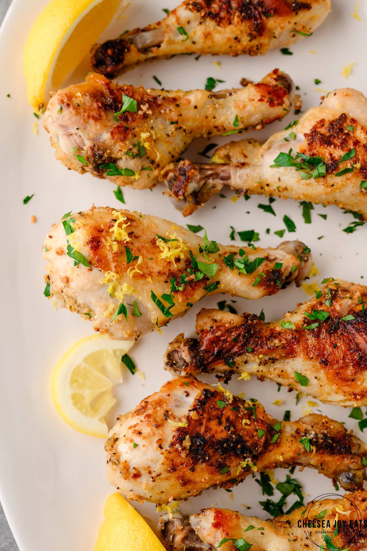 Closeup of oven baked chicken drumsticks seasoned with lemon pepper