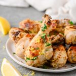 Closeup of lemon pepper chicken drumsticks garnished with parsley