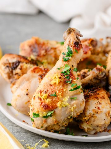 Closeup of lemon pepper chicken drumsticks garnished with parsley