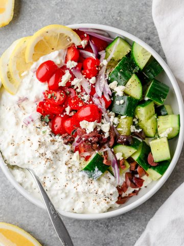 Savory cottage cheese bowl with cucumbers, tomatoes, red onion, and feta cheese