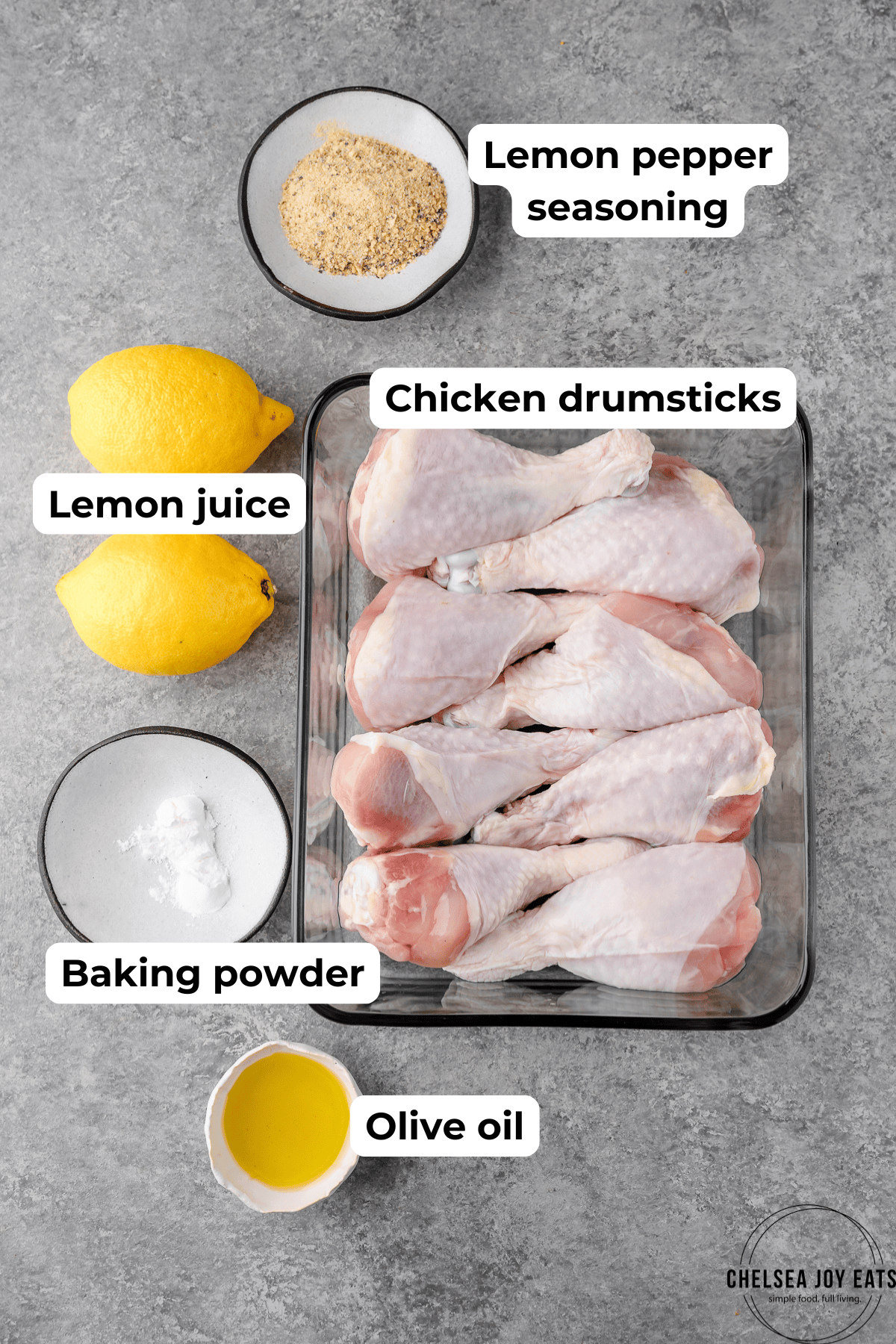 Ingredients for a chicken drumstick recipe, including lemon pepper seaoning, lemons, dhicken drumsticks, and baking powder