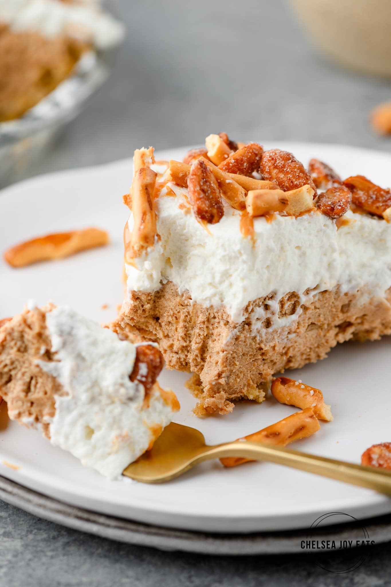 Closeup of a slice of no bake peanut butter pretzel pie with a bit taken out